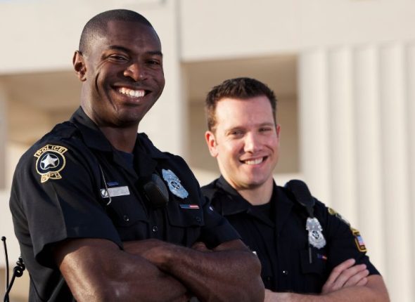 two-male-police-officers-arms-crossed-smiling